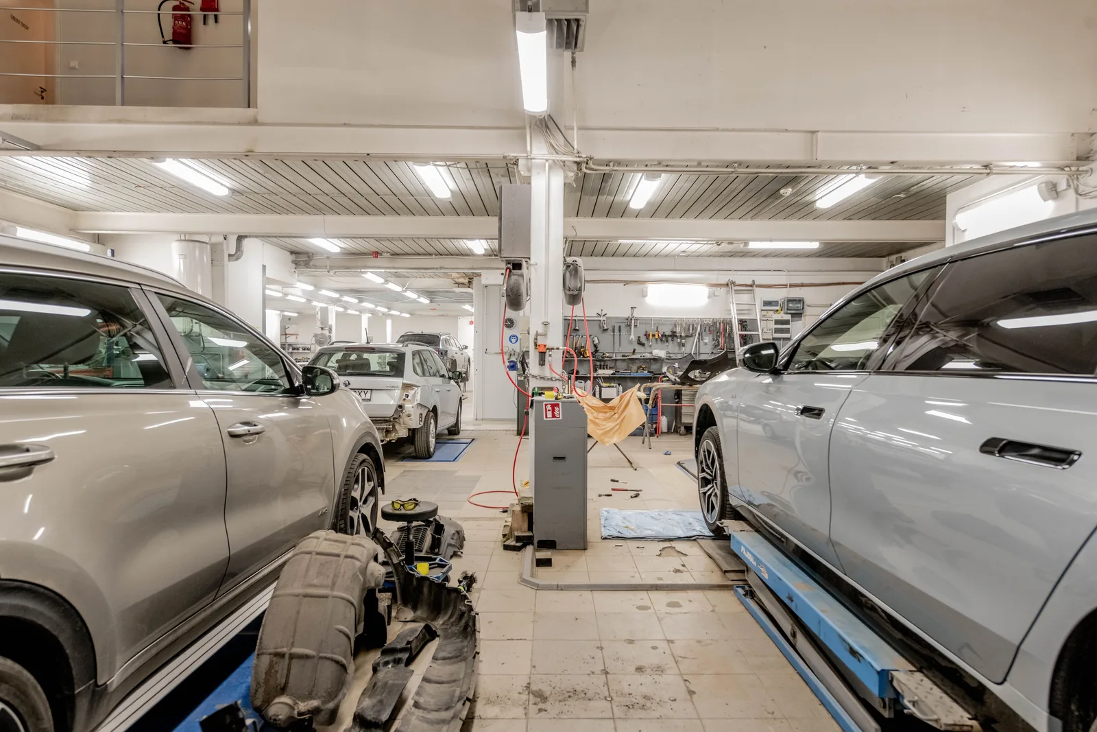 Bright auto repair shop interior with painted walls, ceilings, and service bays