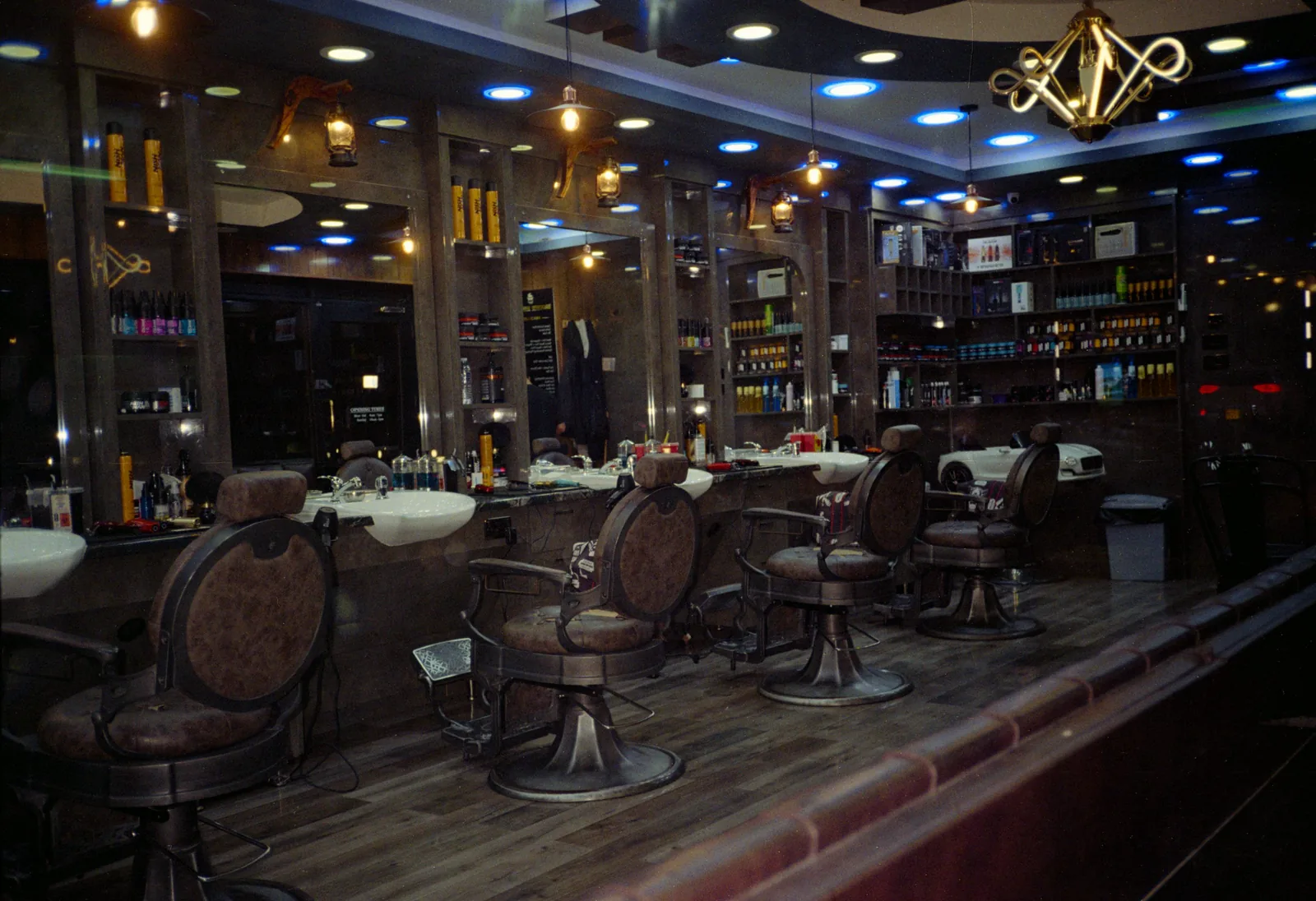 Empty barbershop interior with leather chairs and mirrors