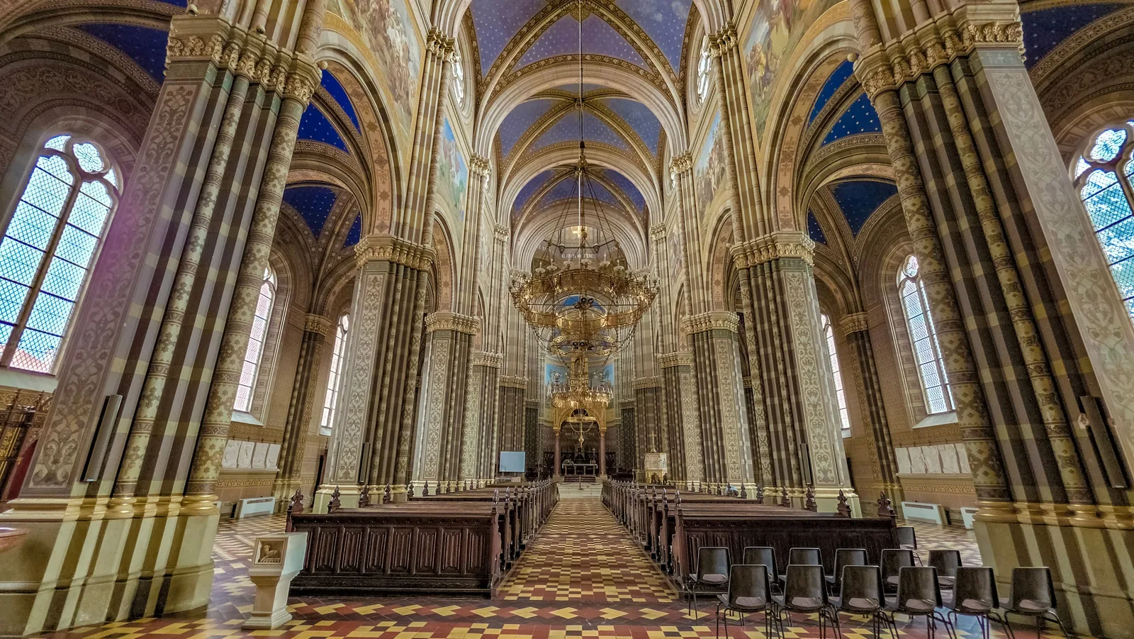 Worship space interior with vaulted arches and chandelier