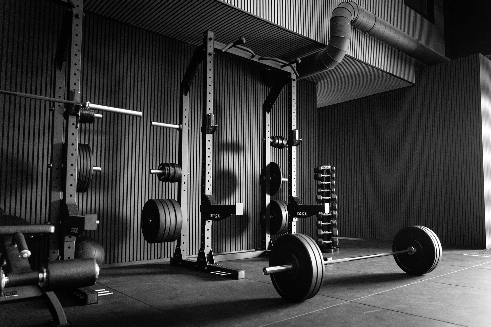 Empty modern fitness center with racks and weights