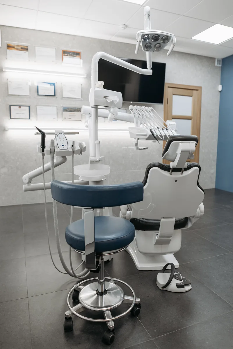 Empty modern dental clinic interior with chair and equipment