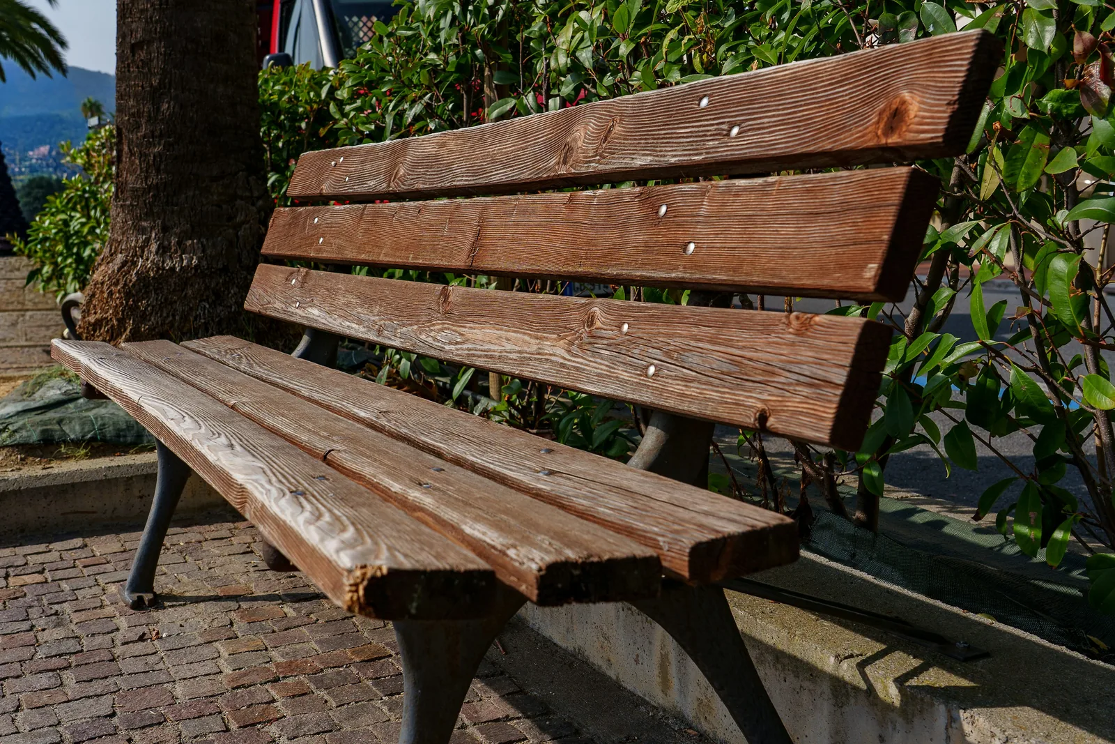 Weathered wooden park bench with visible wood grain