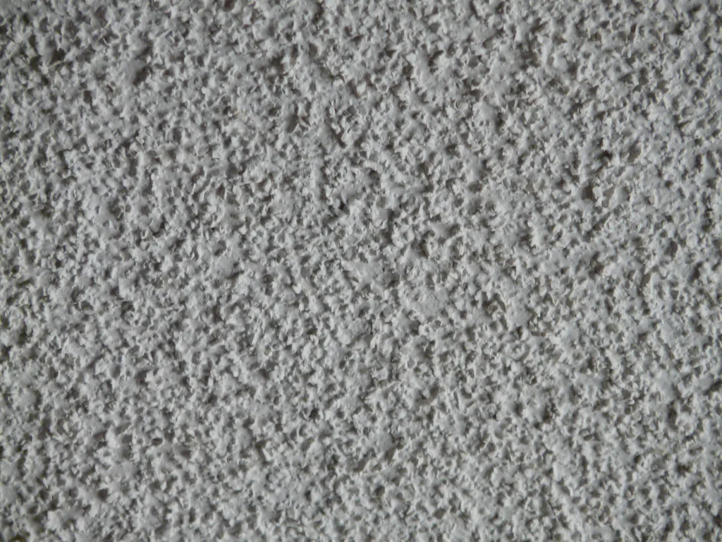 Close-up texture of a popcorn ceiling surface